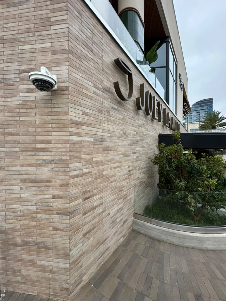 Exterior stacked stone tile installation at Teleferic Barcelona restaurant in La Jolla by Evolution Tile Inc