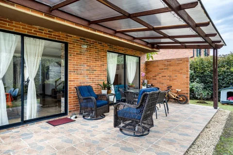 Tiled outdoor patio with wicker chairs and plants