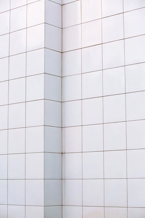 White square wall tile meeting at a corner